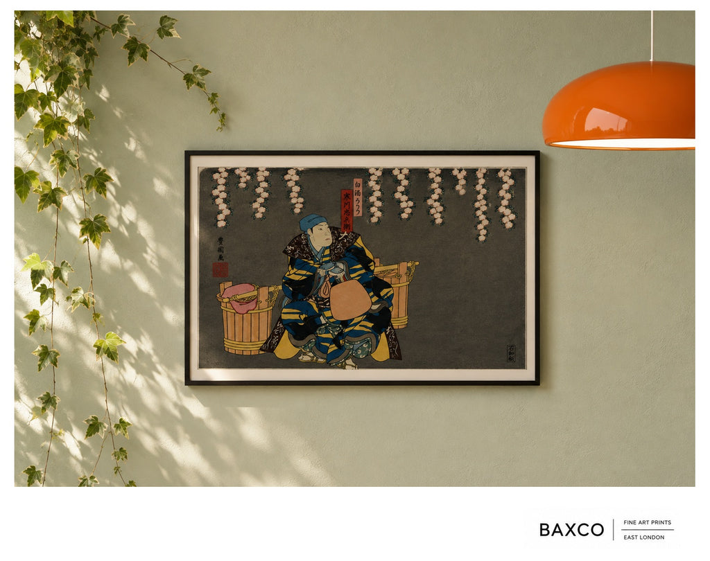 Hanami takes its name from the Japanese tradition of gathering to admire the fleeting beauty of flowers, most famously the spring cherry blossom.

This reproduction of an early 1860s colour woodcut by Utagawa Kunikazu depicts kabuki actors in a confrontation beneath cascading blossoms. Richly patterned robes of deep blue, black and gold stand dramatically against the charcoal ground, while the extraordinary sweep of blossom overhead gives the composition both theatricality and a surprising amount of stillne