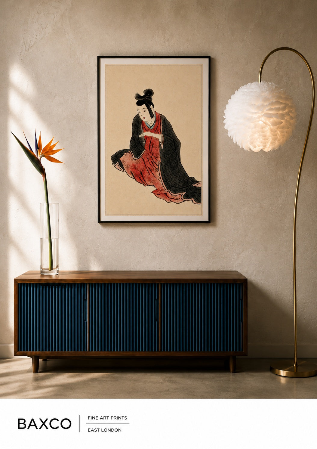 Shizuka takes its name from the Japanese word for “quiet” or “stillness”.

This beautiful reproduction of a 19th-century Japanese painting by an unknown artist captures a solitary figure seated against an expanse of warm, textured paper. Her flowing black outer robe reveals flashes of rich vermilion beneath, while the restrained palette, delicate linework and generous use of negative space give the composition its striking sense of calm and intimacy.