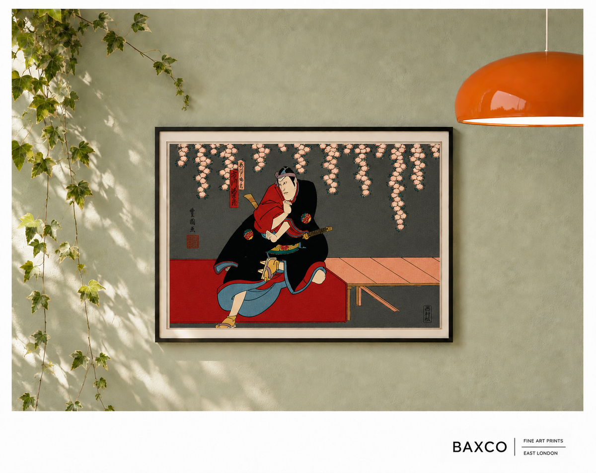 Shōbu takes its name from the Japanese word for a contest or showdown, capturing the tension at the heart of this theatrical scene.

This reproduction of an early 1860s colour woodcut by Utagawa Kunikazu depicts a kabuki actor crouched beneath cascading cherry blossom, his sword held at his side. Bold expanses of black, vermilion, and muted blue contrast with the delicacy of the flowers overhead, giving the composition a powerful sense of anticipation.